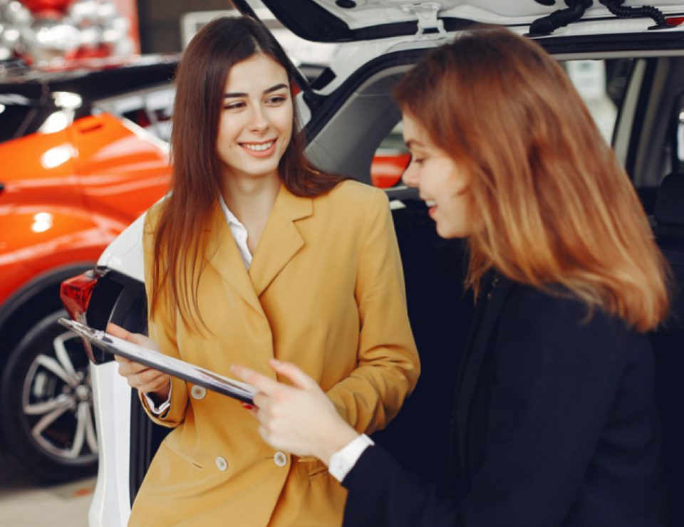 Two women reviewing data on a clipboard