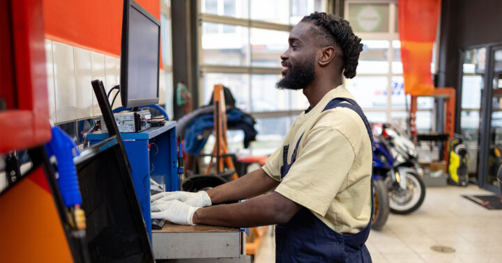 automotive service technician at a computer