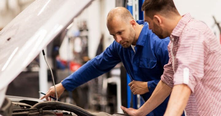 automotive service department technicians workong on a vehicle